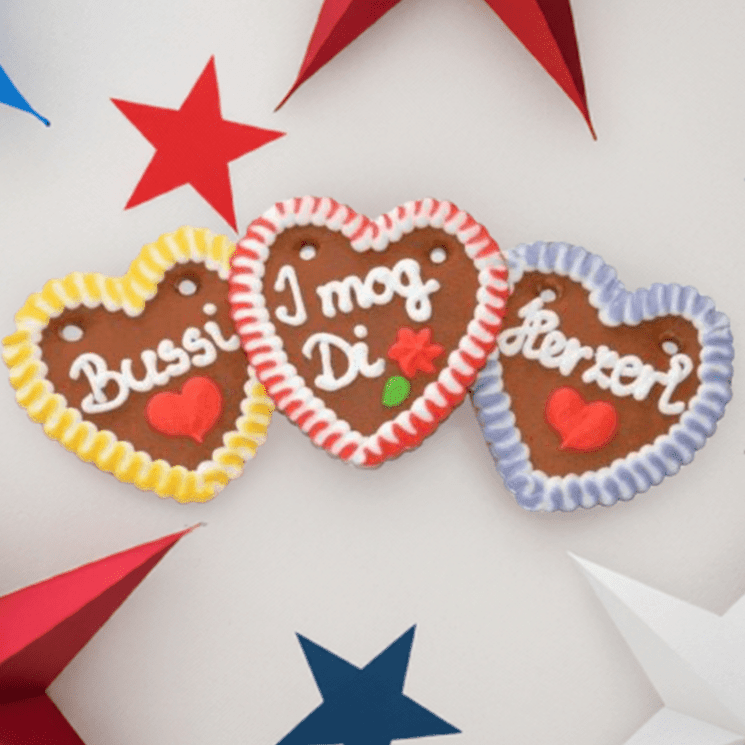 60 Lebkuchenherzen im Karton bayrisch bunt, Liabs Herzl, Spatzl, Mausi 10 cm - Lebkuchenherzen-Fabrik